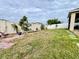 Well-maintained backyard landscaping with trees, plants, and grass along the white vinyl fence at 724 Parker Den Dr, Ruskin, FL 33570