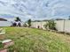 Green backyard with a white fence and landscaping with flowers at 724 Parker Den Dr, Ruskin, FL 33570