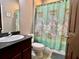 Bathroom featuring a sink, toilet, and shower with a decorative curtain at 724 Parker Den Dr, Ruskin, FL 33570
