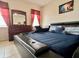 Modern bedroom with leather platform bed and a matching dresser with large mirror at 724 Parker Den Dr, Ruskin, FL 33570
