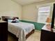 Bedroom with white bedding and a lamp by the window at 724 Parker Den Dr, Ruskin, FL 33570