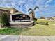 Bahia Lakes community sign with stone base, lush landscaping, and clear street view at 724 Parker Den Dr, Ruskin, FL 33570