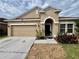 Charming single-story home featuring a well-manicured front yard and an attached garage at 724 Parker Den Dr, Ruskin, FL 33570