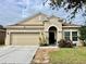 Charming single-story home featuring a two-car garage, neutral paint, and neatly manicured landscaping at 724 Parker Den Dr, Ruskin, FL 33570