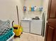 Functional laundry area featuring appliances, shelving, and ample space for organization at 724 Parker Den Dr, Ruskin, FL 33570