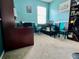 Office space with teal colored walls and carpet flooring at 724 Parker Den Dr, Ruskin, FL 33570