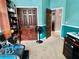 Office space with teal walls featuring shelves, a closet, and tiled flooring beyond the doorway at 724 Parker Den Dr, Ruskin, FL 33570