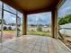 Covered patio with tiled floor, providing a perfect view of the fenced backyard at 724 Parker Den Dr, Ruskin, FL 33570