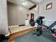 Home gym featuring weightlifting equipment and accessories, with wood and tile flooring at 724 Parker Den Dr, Ruskin, FL 33570