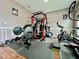 Home gym featuring weightlifting equipment, a stationary bike, and rubber flooring at 724 Parker Den Dr, Ruskin, FL 33570