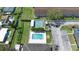 High-angle view of a community pool and tennis courts, surrounded by green landscaping and parking at 11200 102Nd Ave # 74, Seminole, FL 33778