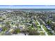Aerial view of neighborhood showcasing mature trees, single Gathering homes and a community lake at 11200 102Nd Ave # 74, Seminole, FL 33778