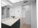 Bathroom featuring black fixtures, quartz countertop and a view of the shower and closet through a large mirror at 11200 102Nd Ave # 74, Seminole, FL 33778