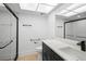 Bright bathroom features a black framed shower and modern vanity at 11200 102Nd Ave # 74, Seminole, FL 33778