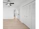 Bedroom features wood floors, a ceiling fan, and a closet with louvered doors at 11200 102Nd Ave # 74, Seminole, FL 33778