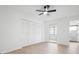 Bedroom featuring wood floors, a ceiling fan, sliding glass doors to a lanai, and a closet with louvered doors at 11200 102Nd Ave # 74, Seminole, FL 33778