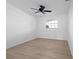 Minimalist bedroom with light wood flooring and a bright window at 11200 102Nd Ave # 74, Seminole, FL 33778