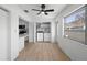 Bright dining area featuring sleek wood floors, a modern ceiling fan, and a convenient washer and dryer closet at 11200 102Nd Ave # 74, Seminole, FL 33778