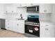 Modern kitchen featuring stainless steel appliances, white cabinets, and quartz countertops at 11200 102Nd Ave # 74, Seminole, FL 33778