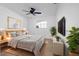 Comfortable main bedroom featuring a ceiling fan, mounted tv, and natural lighting at 11200 102Nd Ave # 74, Seminole, FL 33778
