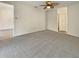 Bedroom featuring neutral paint, ceiling fan, closet, and neutral carpet flooring at 18284 Yale Ave, Port Charlotte, FL 33948