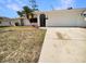 Charming single Gathering home featuring an attached two-car garage and quaint landscaping at 18284 Yale Ave, Port Charlotte, FL 33948