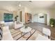 Bright living room featuring modern furnishings, new flooring, and a view of the pool at 18284 Yale Ave, Port Charlotte, FL 33948
