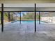 View of the in-ground pool from the covered and screened lanai at 18284 Yale Ave, Port Charlotte, FL 33948