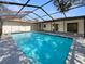 Enjoy the pool in this backyard, with a screened enclosure and spacious patio for relaxation and fun at 18284 Yale Ave, Port Charlotte, FL 33948