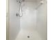 All-white tiled shower with shower head and soap dish at 18284 Yale Ave, Port Charlotte, FL 33948
