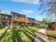 Townhouse backyard featuring large screened patios and manicured lawn with walkway at 2108 Tarpon Landings Dr, Tarpon Springs, FL 34688