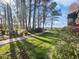 Pathway to lakefront with manicured landscaping and mature trees at 2108 Tarpon Landings Dr, Tarpon Springs, FL 34688