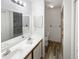 Bright bathroom featuring double sinks and a walk-in shower with stone tile at 2108 Tarpon Landings Dr, Tarpon Springs, FL 34688