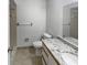 Bright bathroom featuring granite countertops, a modern toilet, and neutral tile flooring at 2108 Tarpon Landings Dr, Tarpon Springs, FL 34688