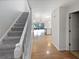 Inviting entryway with staircase, hardwood floors, and open layout to kitchen at 2108 Tarpon Landings Dr, Tarpon Springs, FL 34688