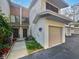 Charming townhouse featuring attached garage, neutral colors, and well-maintained landscaping at 2108 Tarpon Landings Dr, Tarpon Springs, FL 34688