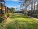 Well-maintained green lawn, community pool, and lush landscaping at 2108 Tarpon Landings Dr, Tarpon Springs, FL 34688