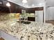 Spacious kitchen with granite countertops, modern appliances, and dark wood cabinets at 2108 Tarpon Landings Dr, Tarpon Springs, FL 34688