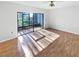 Bright living room featuring hardwood floors and access to screened patio at 2108 Tarpon Landings Dr, Tarpon Springs, FL 34688