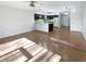Open concept living room and kitchen with hardwood floors and modern appliances at 2108 Tarpon Landings Dr, Tarpon Springs, FL 34688