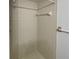 Neutral tile shower featuring a shower head and built-in towel rack at 2108 Tarpon Landings Dr, Tarpon Springs, FL 34688