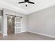 Stylish bedroom featuring a modern sliding door leading to an en-suite bathroom at 24349 Kingsway Cir, Punta Gorda, FL 33983