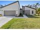 Contemporary home featuring modern architecture, a two-car garage, and front yard at 24349 Kingsway Cir, Punta Gorda, FL 33983