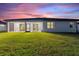 Backyard of home, featuring a screened-in lanai and a freshly cut green lawn at 24470 Kingsway Cir, Punta Gorda, FL 33983