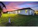 Exterior view of the home showing backyard and lanai at 24470 Kingsway Cir, Punta Gorda, FL 33983