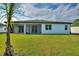 This backyard features a covered, screened in patio perfect for outdoor living at 24470 Kingsway Cir, Punta Gorda, FL 33983