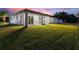 Enjoy this home's expansive backyard and airy screened lanai with sliding glass doors at 24470 Kingsway Cir, Punta Gorda, FL 33983