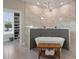 Luxurious bathroom featuring a soaking tub, walk-in closet, and modern chandelier at 24470 Kingsway Cir, Punta Gorda, FL 33983