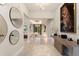 Bright foyer with decorative mirrors and artwork leads to a spacious living area at 24470 Kingsway Cir, Punta Gorda, FL 33983