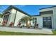 A close view of the front door of the home, enhanced by landscaping at 24470 Kingsway Cir, Punta Gorda, FL 33983